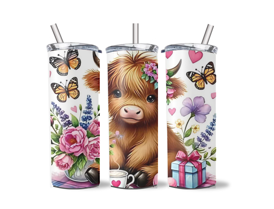 Highland calf sitting in a butterfly garden with gifts tumbler